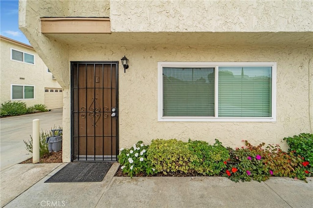 entrance to property featuring stucco siding