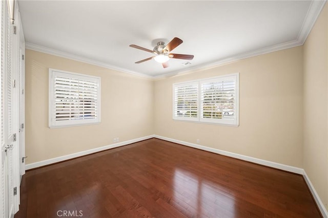 unfurnished room with baseboards, a ceiling fan, dark wood-style flooring, and crown molding