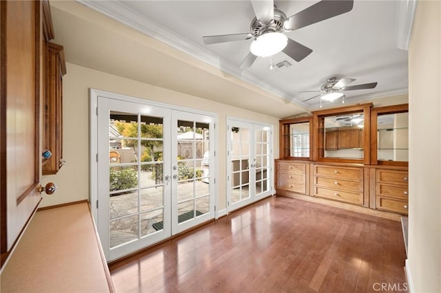 unfurnished sunroom with visible vents, french doors, and a ceiling fan