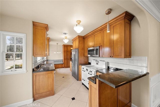 kitchen with visible vents, brown cabinets, decorative light fixtures, stainless steel appliances, and a peninsula