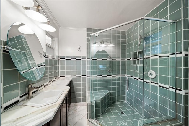 full bathroom featuring vanity, tile walls, a shower stall, and crown molding