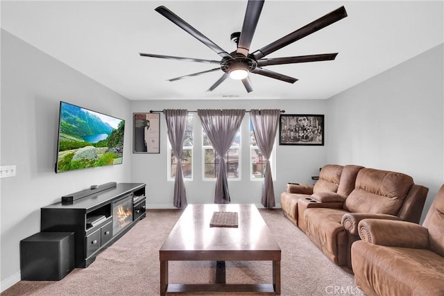 living room with visible vents, light colored carpet, a ceiling fan, and baseboards