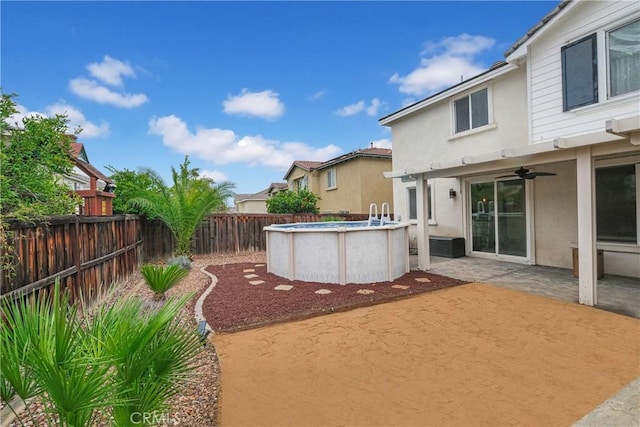 view of yard with a patio area, a fenced in pool, a ceiling fan, and a fenced backyard