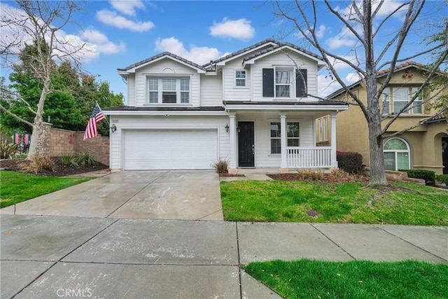 traditional-style home with an attached garage, covered porch, and driveway