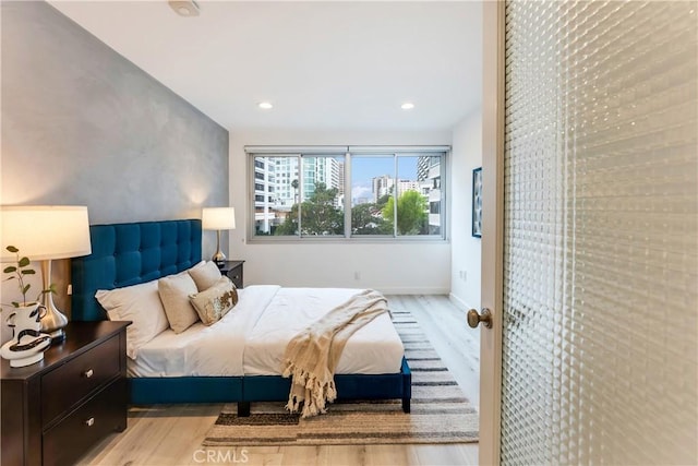 bedroom featuring recessed lighting, baseboards, and light wood finished floors