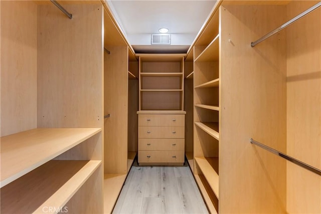 walk in closet featuring light wood-style flooring and visible vents