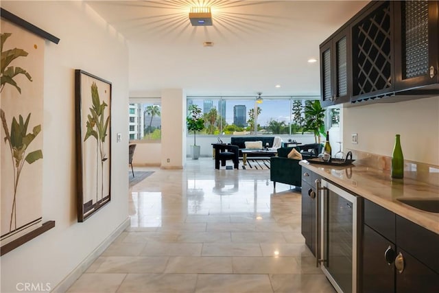 interior space featuring recessed lighting, baseboards, and beverage cooler