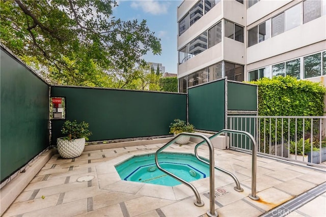 view of pool with a community hot tub and a patio area