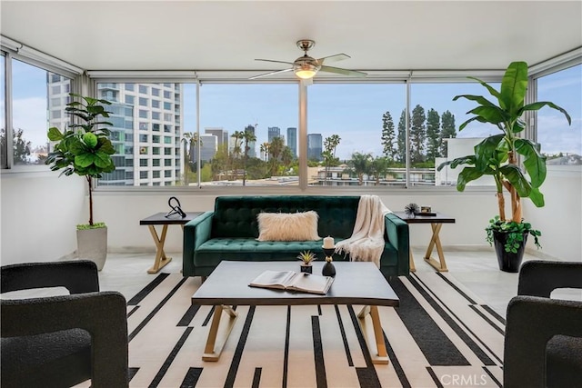 sunroom featuring a city view and a ceiling fan