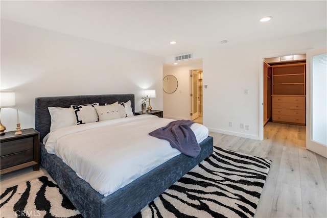 bedroom featuring recessed lighting, visible vents, light wood finished floors, and baseboards