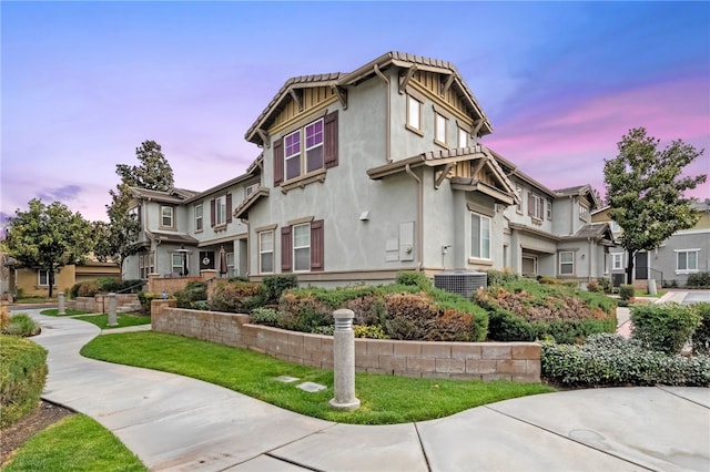 property exterior at dusk featuring stucco siding