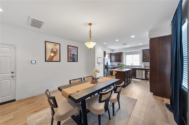 dining space with recessed lighting, light wood-style floors, visible vents, and baseboards