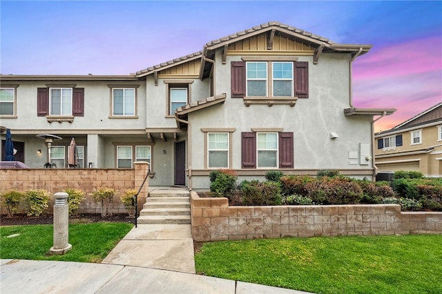 multi unit property featuring stucco siding and a tile roof