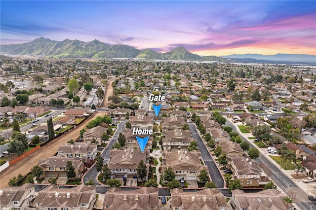 aerial view at dusk with a mountain view and a residential view