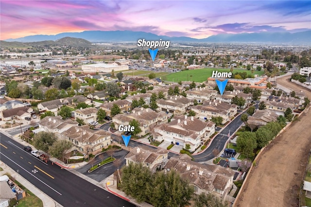 aerial view at dusk with a mountain view and a residential view