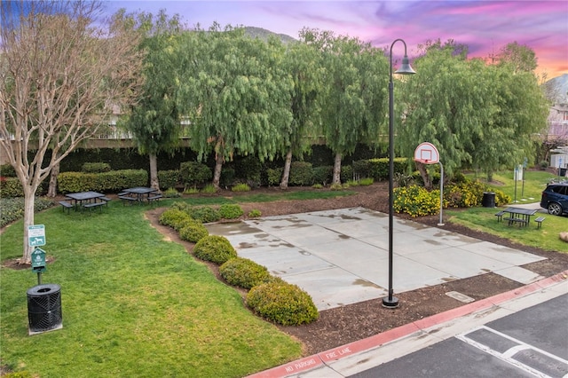 view of basketball court featuring a lawn