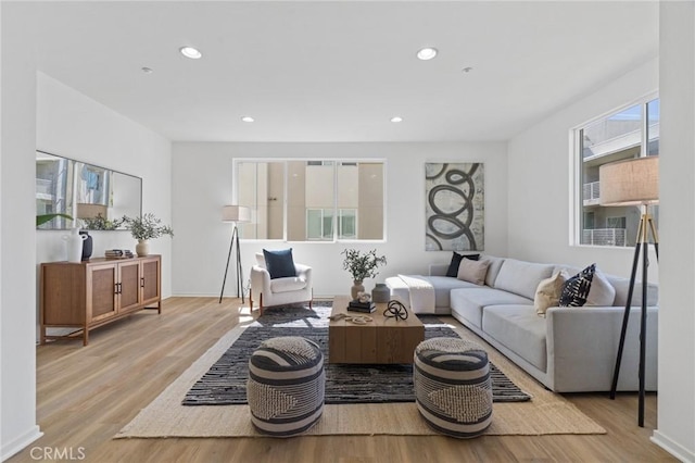 living area with recessed lighting and wood finished floors