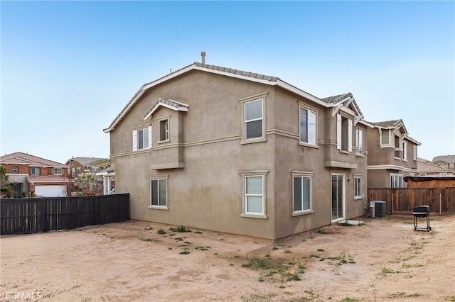 view of property exterior featuring cooling unit, fence, and stucco siding