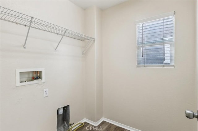 washroom featuring baseboards, washer hookup, dark wood-style flooring, and laundry area