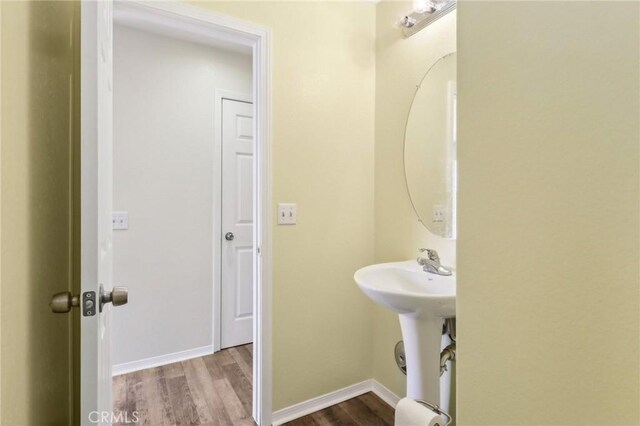 bathroom with baseboards and wood finished floors