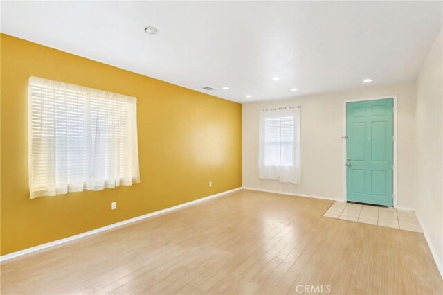 entrance foyer with visible vents, recessed lighting, light wood-style floors, and baseboards