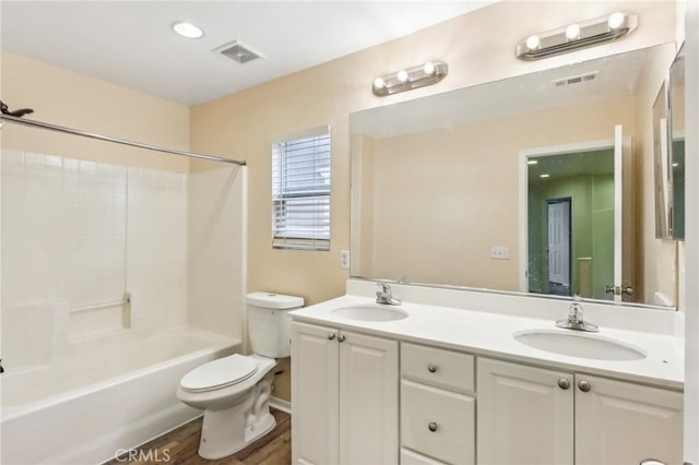 full bath featuring toilet, visible vents, and a sink