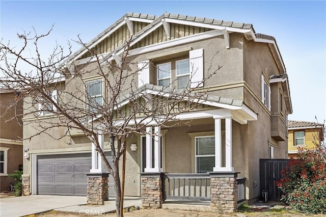 craftsman house with concrete driveway, stucco siding, covered porch, stone siding, and an attached garage