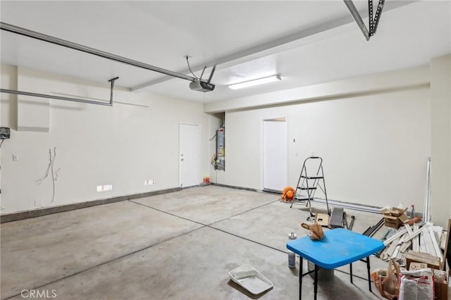 garage featuring secured water heater, a garage door opener, and baseboards