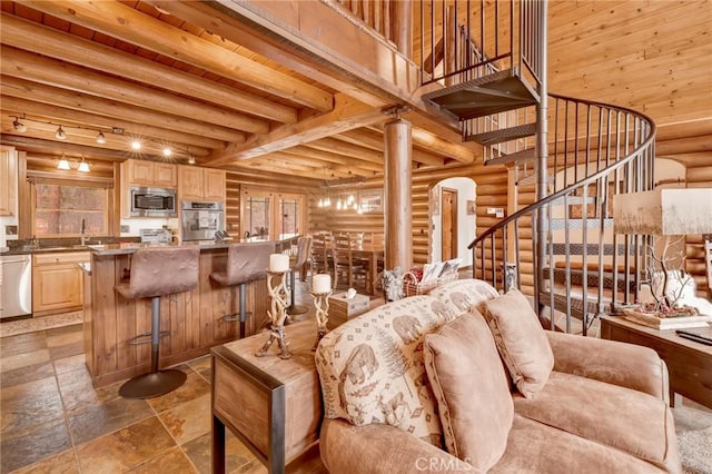 living area featuring arched walkways, stairs, wood ceiling, a towering ceiling, and beamed ceiling