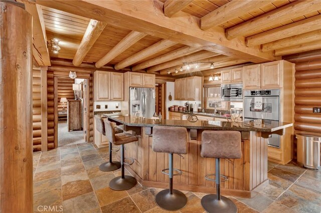 kitchen featuring beam ceiling, stone tile floors, wood ceiling, and appliances with stainless steel finishes