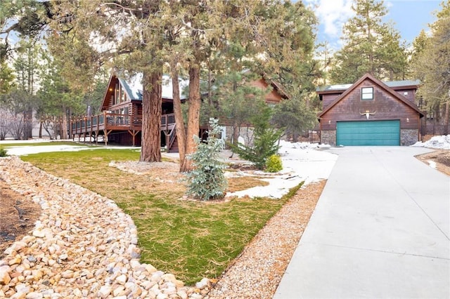 view of front of home featuring driveway and a wooden deck