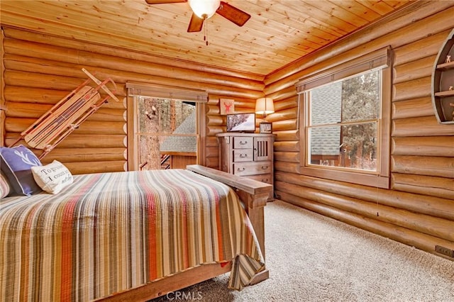 unfurnished bedroom with carpet flooring, multiple windows, and wooden ceiling