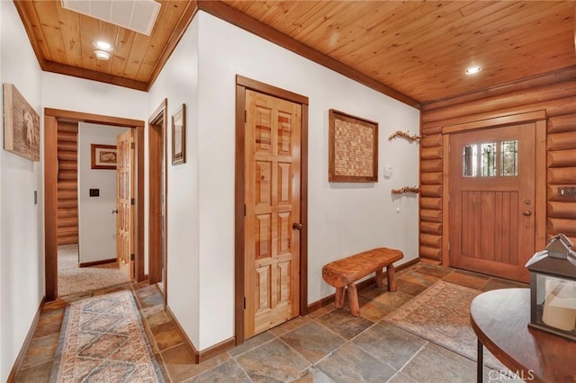 entryway featuring baseboards, wood ceiling, recessed lighting, rustic walls, and stone tile flooring