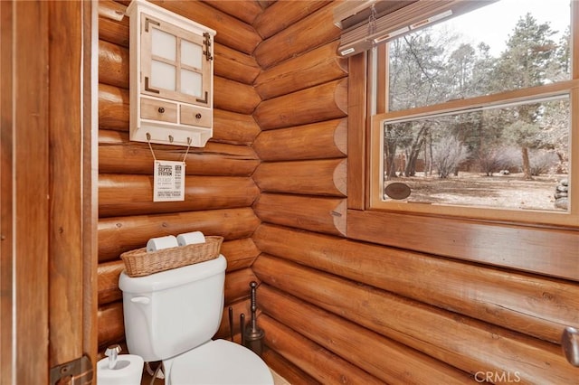 half bath with rustic walls and toilet