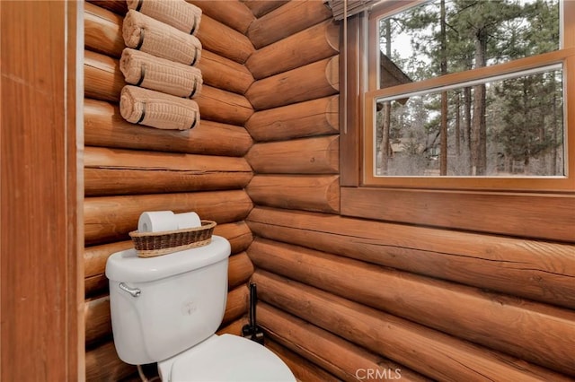 bathroom with rustic walls and toilet