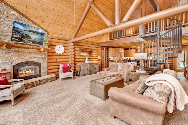 living area featuring stairway, high vaulted ceiling, a fireplace, wood ceiling, and rustic walls