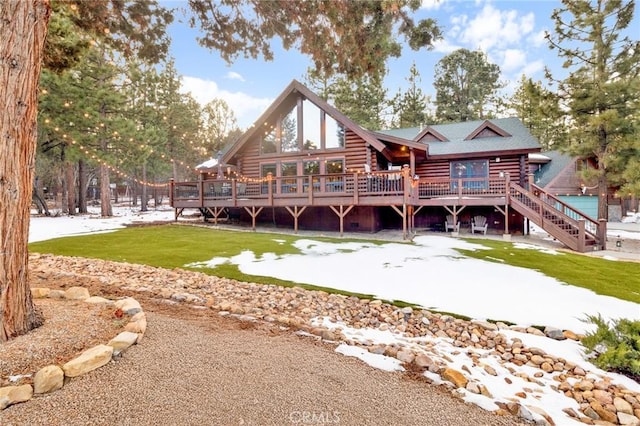 back of house with a deck, stairway, log siding, and a lawn