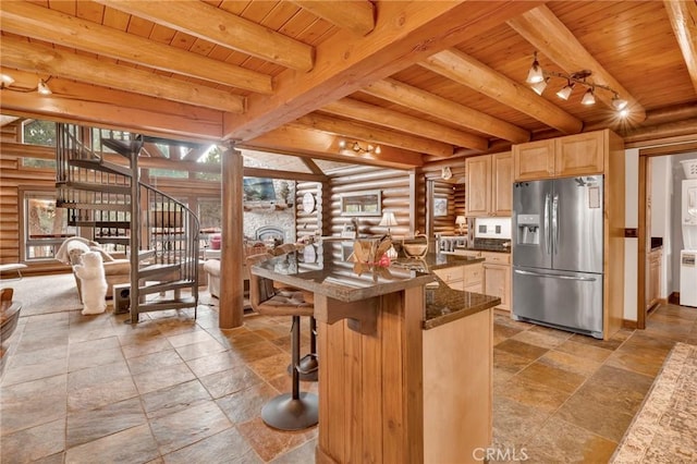 kitchen with white microwave, stainless steel fridge, wood ceiling, and a wealth of natural light