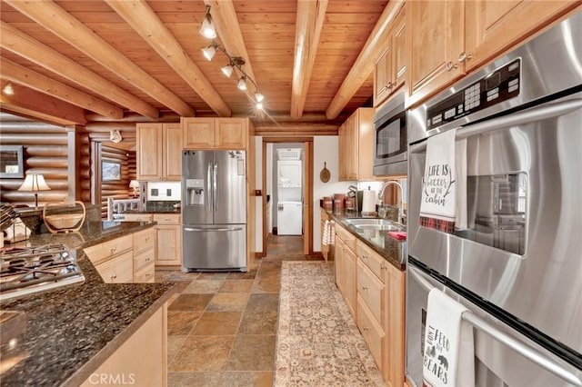 kitchen with light brown cabinets, wood ceiling, appliances with stainless steel finishes, log walls, and a sink