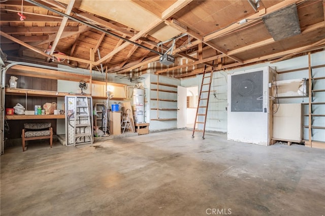 garage with strapped water heater and a garage door opener