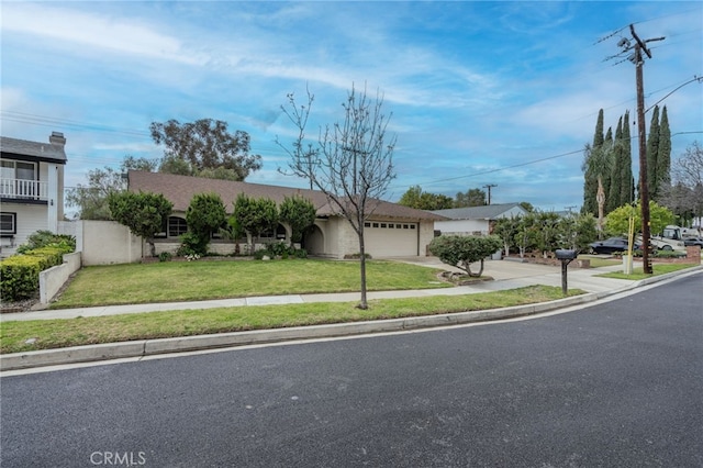 view of front of house featuring concrete driveway, a garage, fence, and a front lawn