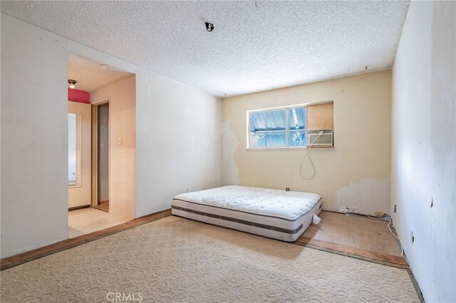 bedroom featuring cooling unit and a textured ceiling