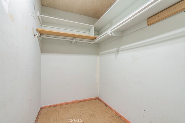 walk in closet featuring light floors