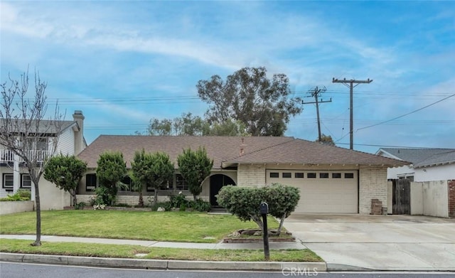 single story home featuring a front yard, fence, driveway, an attached garage, and brick siding