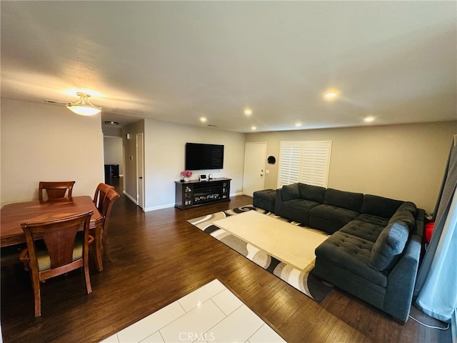 living area with dark wood finished floors, recessed lighting, and baseboards