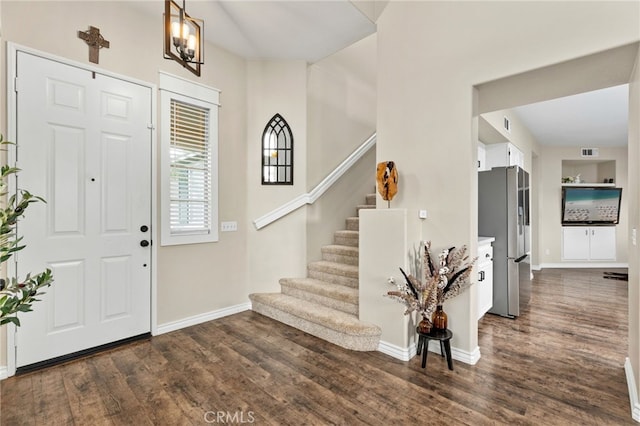 entryway featuring stairway, baseboards, visible vents, and dark wood finished floors