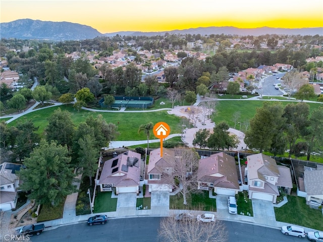 aerial view at dusk with a mountain view and a residential view