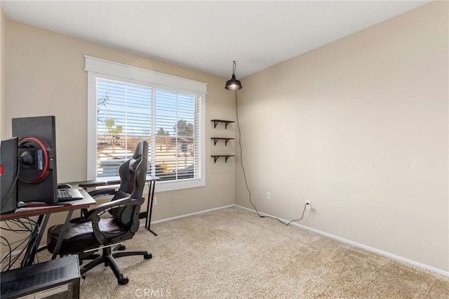 carpeted office space featuring baseboards