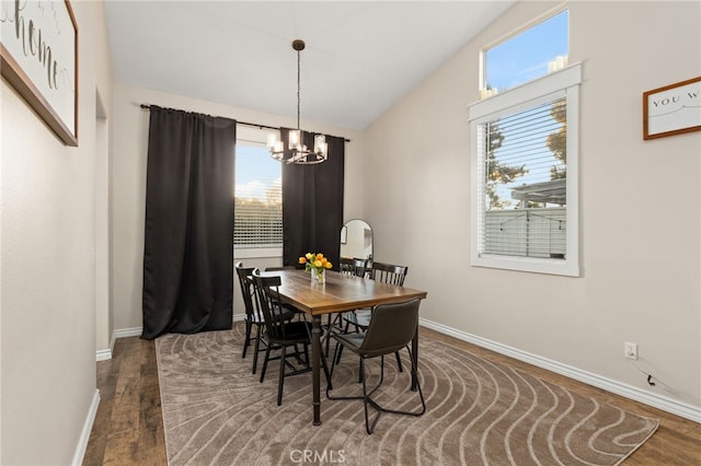 dining area featuring a notable chandelier, wood finished floors, and baseboards