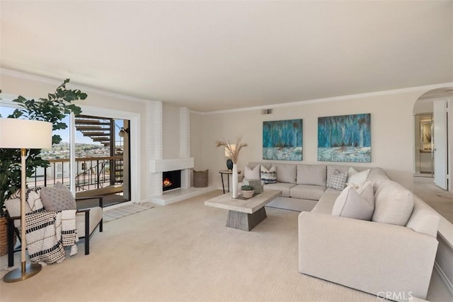 22364 Manacor Unit 9, Mission Viejo, CA 92692 - living area featuring carpet floors, a brick fireplace, ornamental molding, and arched walkways